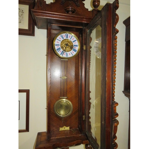 704 - AN ANTIQUE VIENNA WALLCLOCK WITH ENAMELLED DIAL