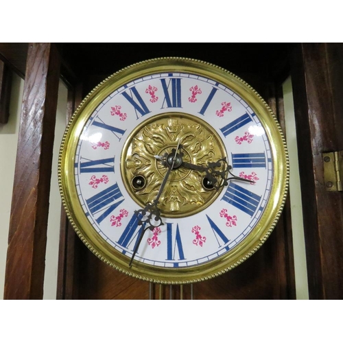 704 - AN ANTIQUE VIENNA WALLCLOCK WITH ENAMELLED DIAL