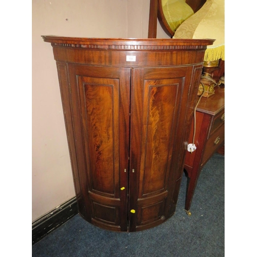 733 - AN ANTIQUE MAHOGANY BOW-FRONT HANGING CORNER CUPBOARD