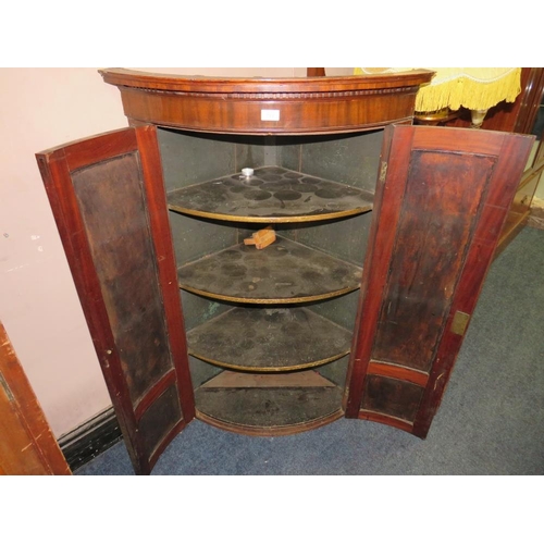 733 - AN ANTIQUE MAHOGANY BOW-FRONT HANGING CORNER CUPBOARD