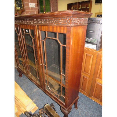 756 - A 20TH CENTURY MAHOGANY GLAZED THREE DOOR BOOKCASE ON BALL AND CLAW FEET 126 X 145 CM