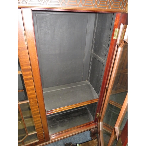 756 - A 20TH CENTURY MAHOGANY GLAZED THREE DOOR BOOKCASE ON BALL AND CLAW FEET 126 X 145 CM