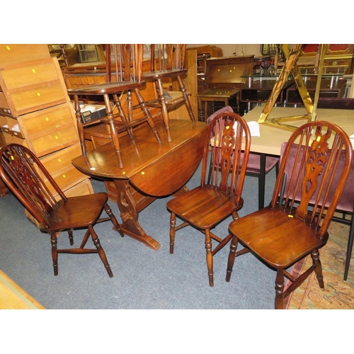 828 - AN OAK DROPLEAF TABLE AND FIVE HOOP BACK CHAIRS