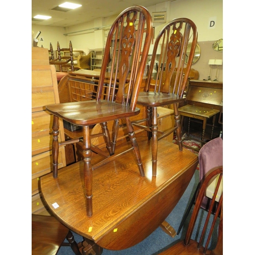 828 - AN OAK DROPLEAF TABLE AND FIVE HOOP BACK CHAIRS