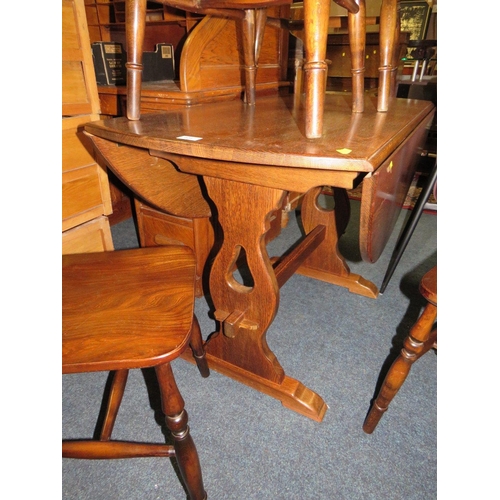 828 - AN OAK DROPLEAF TABLE AND FIVE HOOP BACK CHAIRS