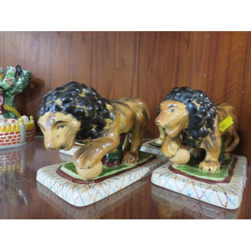 255 - FOUR REPRODUCTION STAFFORDSHIRE STYLE LIONS