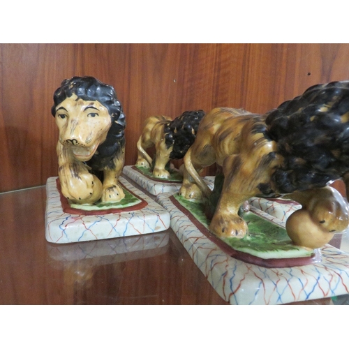 255 - FOUR REPRODUCTION STAFFORDSHIRE STYLE LIONS