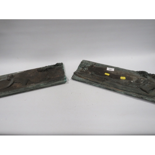 292 - TWO CAST METAL PLAQUES OF MALE STUDIES IN CANOES