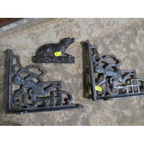 311 - TWO CAST IRON BRACKETS WITH FIGURAL DETAIL TOGETHER WITH A SMALL CAST IRON DOG (3)