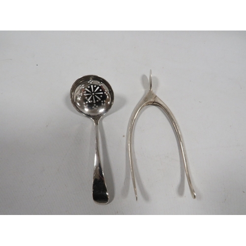 380A - A PAIR OF HALLMARKED SILVER WISHBONE SUGAR TONGS TOGETHER WITH A HALLMARKED SILVER SIFTER SPOON (2)