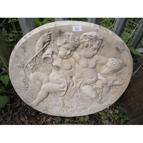 612 - A CONCRETE GARDEN HANGING WALL PLAQUE DEPICTING CHERUBS