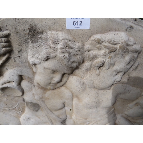 612 - A CONCRETE GARDEN HANGING WALL PLAQUE DEPICTING CHERUBS