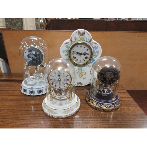 97 - FOUR DECORATIVE MANTLE CLOCKS TO INCLUDE  THREE UNDER GLASS DOMES COMPRISING AN ELVIS PRESLEY COLLEC... 