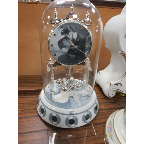 97 - FOUR DECORATIVE MANTLE CLOCKS TO INCLUDE  THREE UNDER GLASS DOMES COMPRISING AN ELVIS PRESLEY COLLEC... 