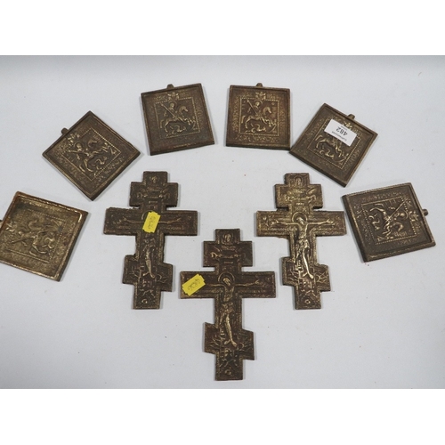 482 - A COLLECTION OF SIX ROUGH CAST BRASS ORTHODOX CRUCIFIXES AND ST GEORGE PLAQUE, MADE FOR THE TOURIST ... 