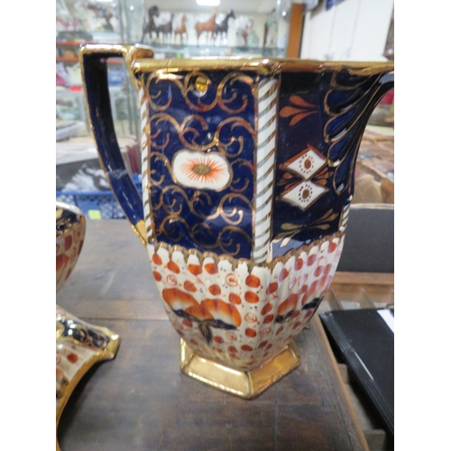 144 - A VICTORIAN STYLE TEAPOT AND STAND TOGETHER WITH A WATER JUG IN IMARI COLOURS A/F