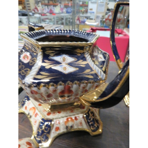 144 - A VICTORIAN STYLE TEAPOT AND STAND TOGETHER WITH A WATER JUG IN IMARI COLOURS A/F