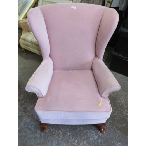 843 - A QUEEN ANNE STYLE WINGED BACK CHAIR