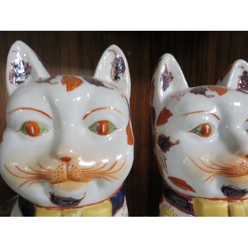 276 - A PAIR OF REPRODUCTION ORIENTAL STYLE CERAMIC CATS