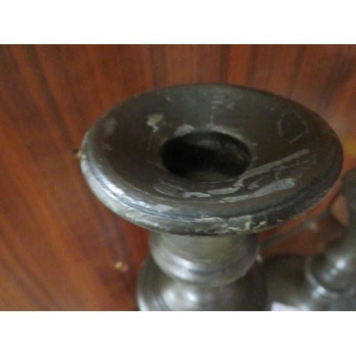 299 - A PAIR OF ANTIQUE PEWTER CANDLESTICKS