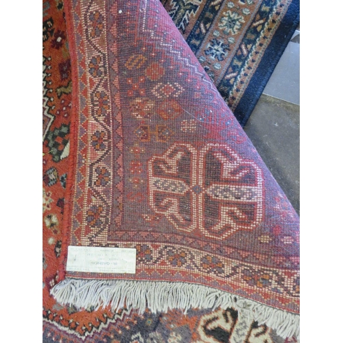 764 - TWO EASTERN WOOLLEN RUGS - RED / BLACK GROUND 128 X 76 CM AND 170 X 110 CM (2)