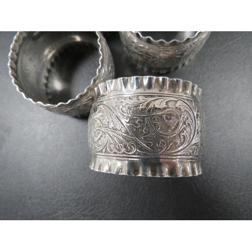 348 - FOUR HALLMARKED SILVER NAPKIN RINGS