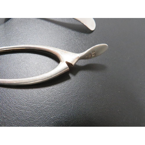 349 - A PAIR OF HALLMARKED SILVER WISHBONE SUGAR TONGS TOGETHER WITH A HALLMARKED SILVER SIFTER SPOON (2)