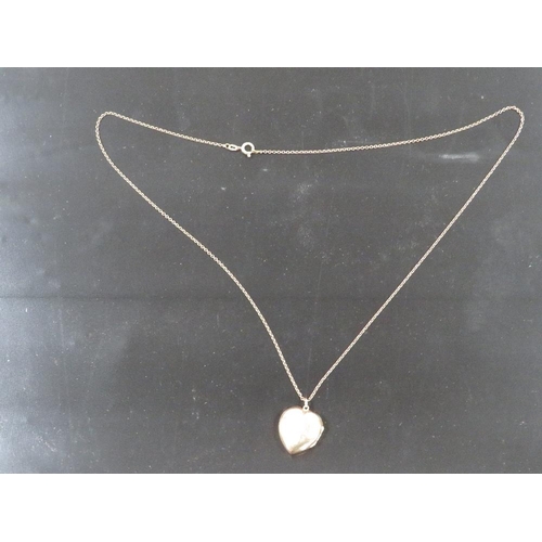 395 - A LOCKET ON CHAIN MARKED 9CT GOLD BACK AND FRONT