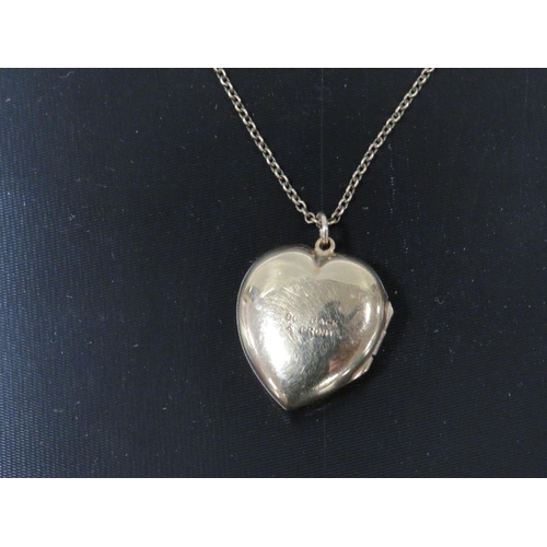 395 - A LOCKET ON CHAIN MARKED 9CT GOLD BACK AND FRONT