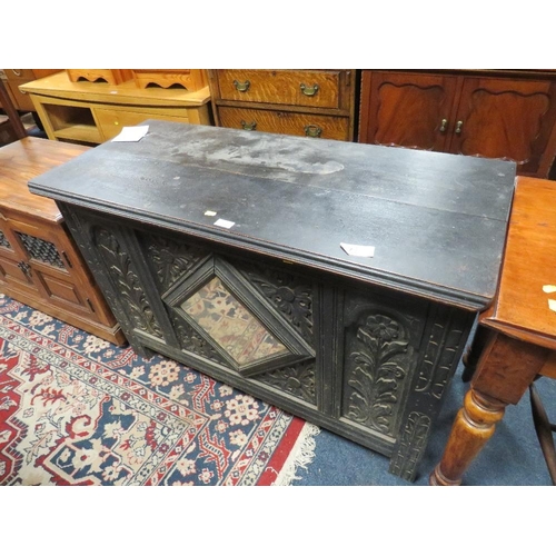 804 - AN ANTIQUE OAK CARVED COFFER WITH MIRROR DETAIL - W 110 CM