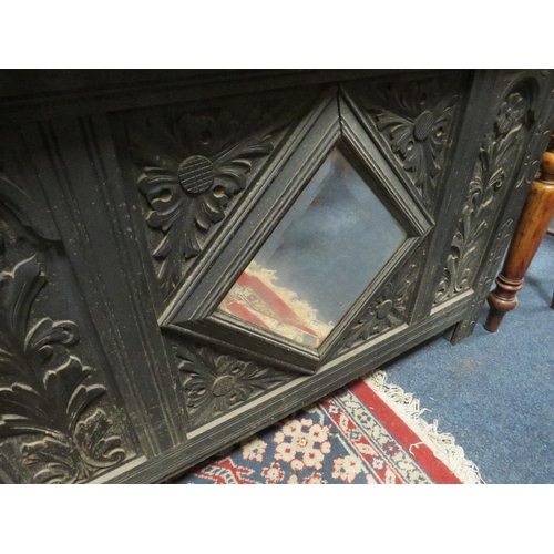 804 - AN ANTIQUE OAK CARVED COFFER WITH MIRROR DETAIL - W 110 CM