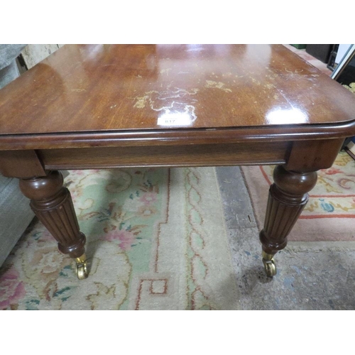 817 - A MAHOGANY COFFEE TABLE WITH BRASS CASTORS