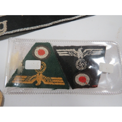 448 - A COLLECTION OF MILITARY TYPE BADGES AND PATCHES