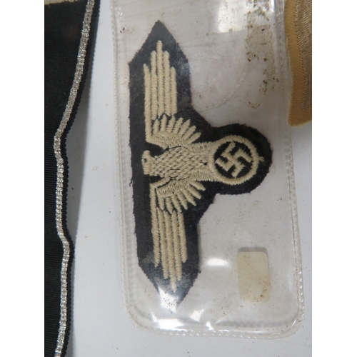 448 - A COLLECTION OF MILITARY TYPE BADGES AND PATCHES