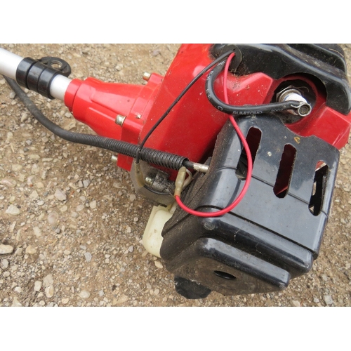 654 - A LARGE PETROL STRIMMER WITH EXTRA ATTACHMENTS