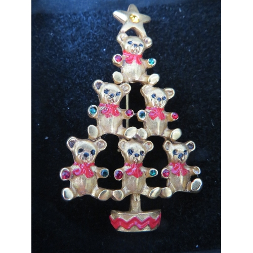 6 - A SELECTION OF FOUR BUTLER AND WILSON CHRISTMAS TREE BROOCHES, together with a Butler and Wilson rei... 