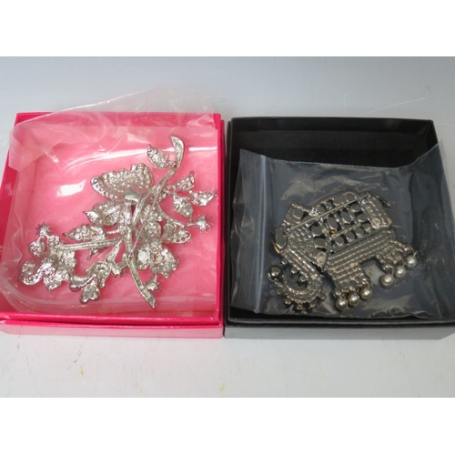 7 - TWO BUTLER AND WILSON COSTUME BROOCHES, comprising an elephant - W 8.5 cm, and a floral spray - W 11... 