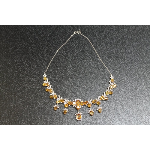 88 - A WHITE METAL GEM SET DIAMOND AND CITRINE NECKLACE STAMPED 585, set with thirty one citrine style st... 