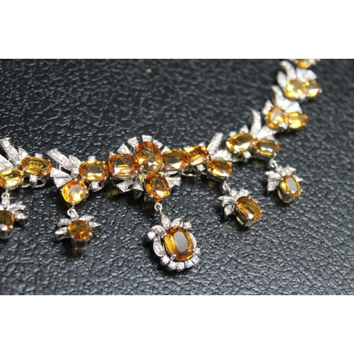 88 - A WHITE METAL GEM SET DIAMOND AND CITRINE NECKLACE STAMPED 585, set with thirty one citrine style st... 