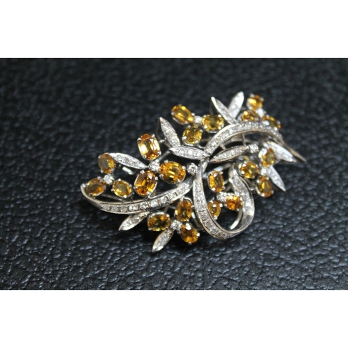 90 - AN UNMARKED WHITE METAL GEM SET BROOCH, set with twenty one citrine style stones and diamonds, appro... 