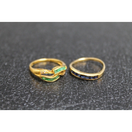 100 - TWO 14K YELLOW METAL RINGS, one set with sapphires, the other with emeralds on a split band, approx ... 