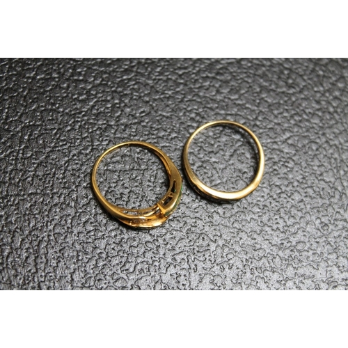 100 - TWO 14K YELLOW METAL RINGS, one set with sapphires, the other with emeralds on a split band, approx ... 