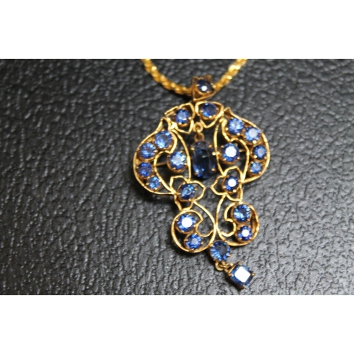 111 - AN ORNATE SAPPHIRE PENDANT, set in unmarked yellow metal and on a similar chain with simple s link f... 