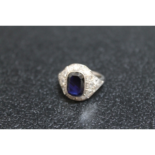 117 - AN ART DECO STYLE SAPPHIRE AND DIAMOND RING, having an emerald cut style sapphire measuring approx 1... 