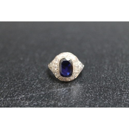 117 - AN ART DECO STYLE SAPPHIRE AND DIAMOND RING, having an emerald cut style sapphire measuring approx 1... 