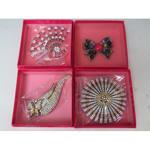 17 - A SELECTION OF FOUR BUTLER AND WILSON COSTUME BROOCHES, to include a large articulated clear & citru... 