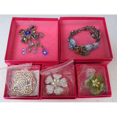 18 - A BUTLER AND WILSON FRUIT THEMED CRYSTAL SET HINGED BANGLE, together with three smaller floral brooc... 