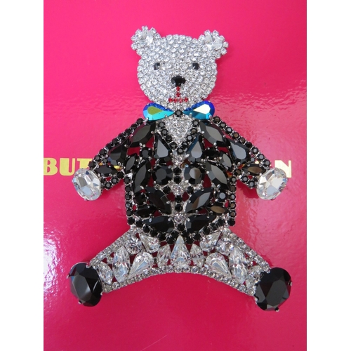 23 - A LARGE BUTLER AND WILSON TEDDY BEAR BROOCH, H 12 cm, together with a floral spray brooch - H 12 cm,... 