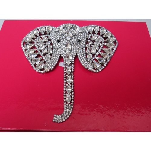 27 - A LARGE BUTLER AND WILSON CLEAR DIAMANTE ELEPHANT BROOCH, with articulated trunk, W 11.5 cm