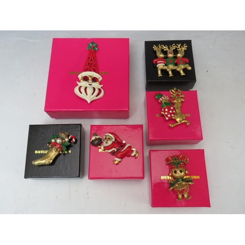 31 - A COLLECTION OF BUTLER AND WILSON CHRISTMAS THEMED BROOCHES, comprising a large Santa brooch and fiv... 